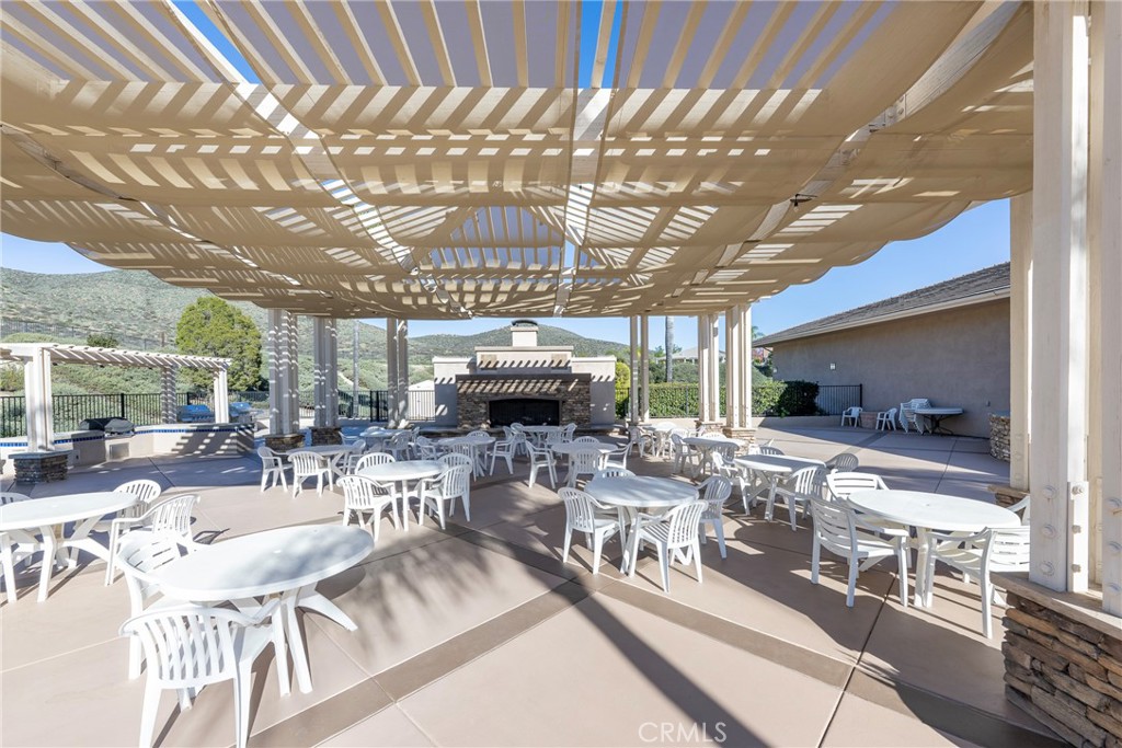27956 Crystal Spring Drive Menifee, CA 92584 - Photo 71 of 75 a view of a patio with table and chairs potted plants with wooden floor