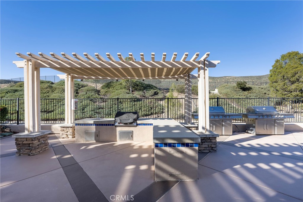 27956 Crystal Spring Drive Menifee, CA 92584 - Photo 72 of 75 a view of a patio with swimming pool and sitting area