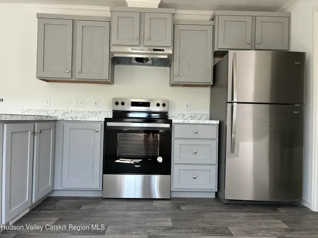a kitchen with stainless steel appliances a stove a refrigerator and cabinets