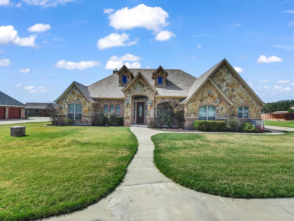 169 Pack Saddle Trail Weatherford, TX 76088 - Photo 2 of 40 a front view of a house with garden
