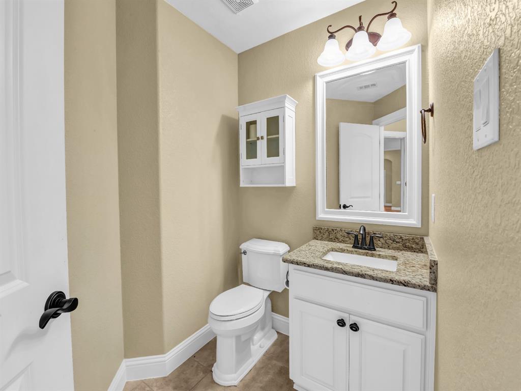169 Pack Saddle Trail Weatherford, TX 76088 - Photo 24 of 40 a bathroom with a granite countertop sink toilet and shower