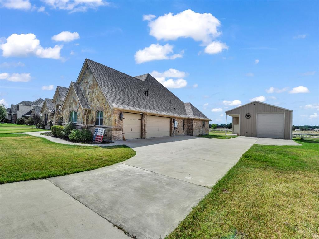 169 Pack Saddle Trail Weatherford, TX 76088 - Photo 33 of 40 a front view of house with yard and trees in the background