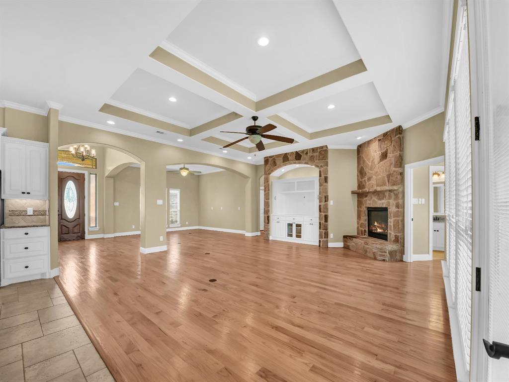 169 Pack Saddle Trail Weatherford, TX 76088 - Photo 6 of 40 a view of a livingroom with a fireplace a chandelier and wooden floor