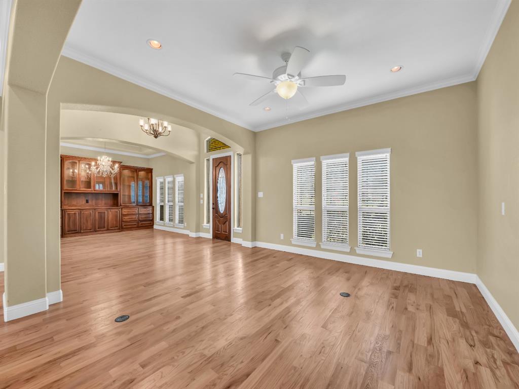 169 Pack Saddle Trail Weatherford, TX 76088 - Photo 8 of 40 a view of an empty room with wooden floor and a window