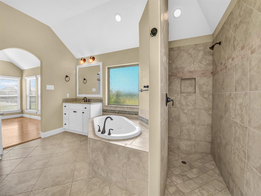 169 Pack Saddle Trail Weatherford, TX 76088 - Photo 9 of 40 a spacious bathroom with a granite countertop sink a toilet a mirror and shower