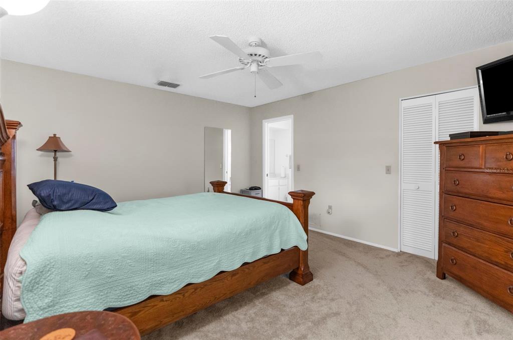 2509 Westchester Boulevard Spring Hill, FL 34606 - Photo 11 of 29 a bedroom with a bed and a ceiling fan