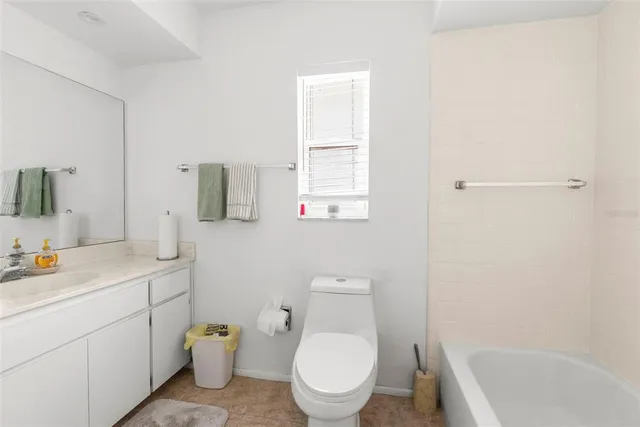 a dining room with furniture and a large window