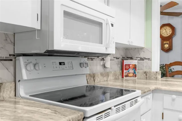 a kitchen with granite countertop a sink and a large window
