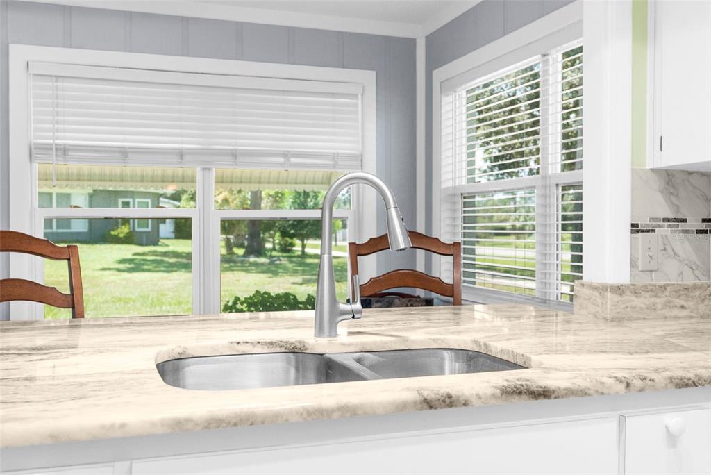 2509 Westchester Boulevard Spring Hill, FL 34606 - Photo 15 of 29 a kitchen with granite countertop a sink and a large window