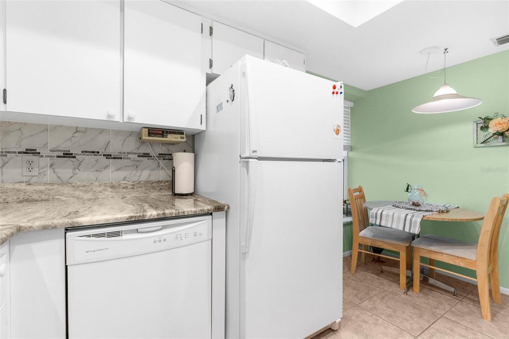 2509 Westchester Boulevard Spring Hill, FL 34606 - Photo 16 of 29 a white refrigerator freezer sitting in a kitchen