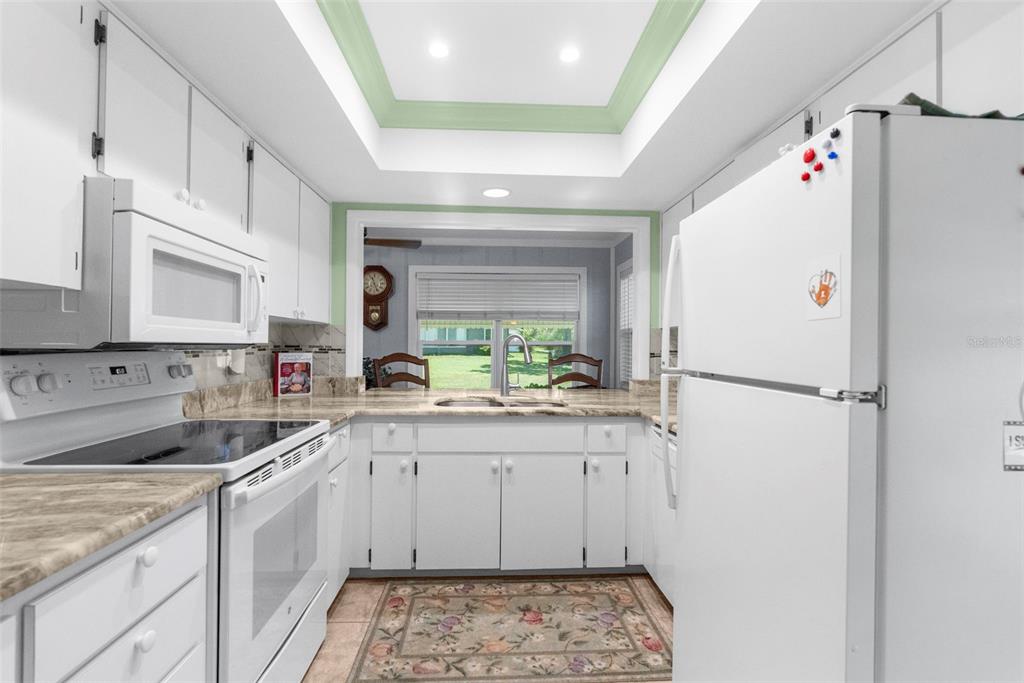 2509 Westchester Boulevard Spring Hill, FL 34606 - Photo 17 of 29 a kitchen with a sink a refrigerator and cabinets