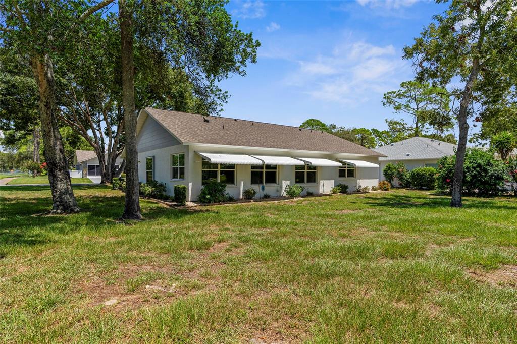 2509 Westchester Boulevard Spring Hill, FL 34606 - Photo 23 of 29 a front view of a house with a garden