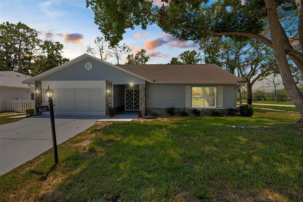 2509 Westchester Boulevard Spring Hill, FL 34606 - Photo 29 of 29 a front view of a house with a garden