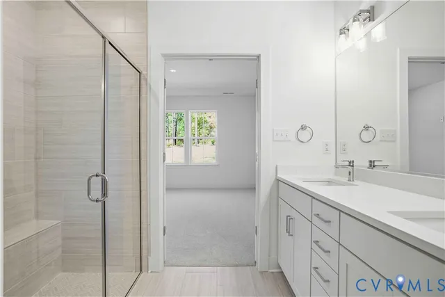 a bathroom with a granite countertop sink a mirror and a shower