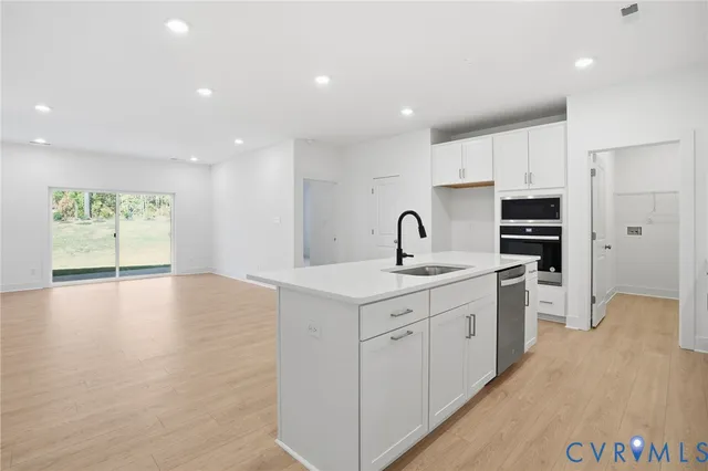 a kitchen with a sink stainless steel appliances and cabinets