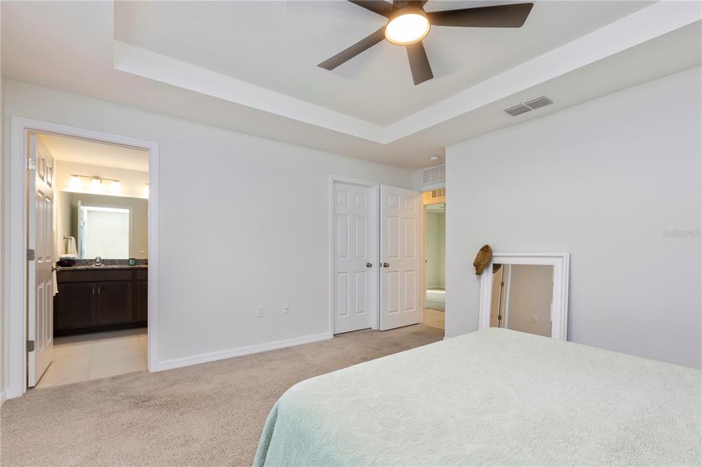 10 Rale Place Palm Coast, FL 32164 - Photo 15 of 27 a bedroom with a bed and a chandelier