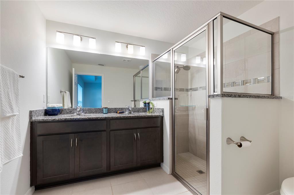 10 Rale Place Palm Coast, FL 32164 - Photo 16 of 27 a bathroom with a granite countertop sink a mirror and a shower