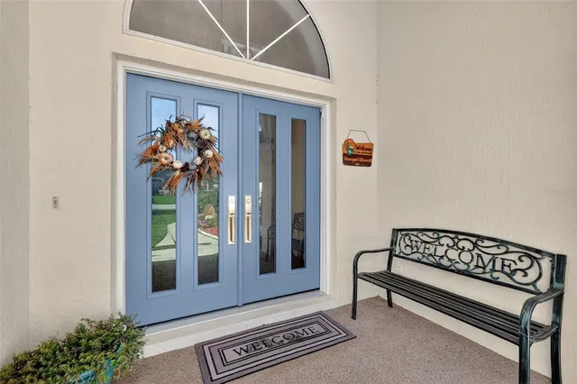 a view of a hallway with wooden floor and a potted plant