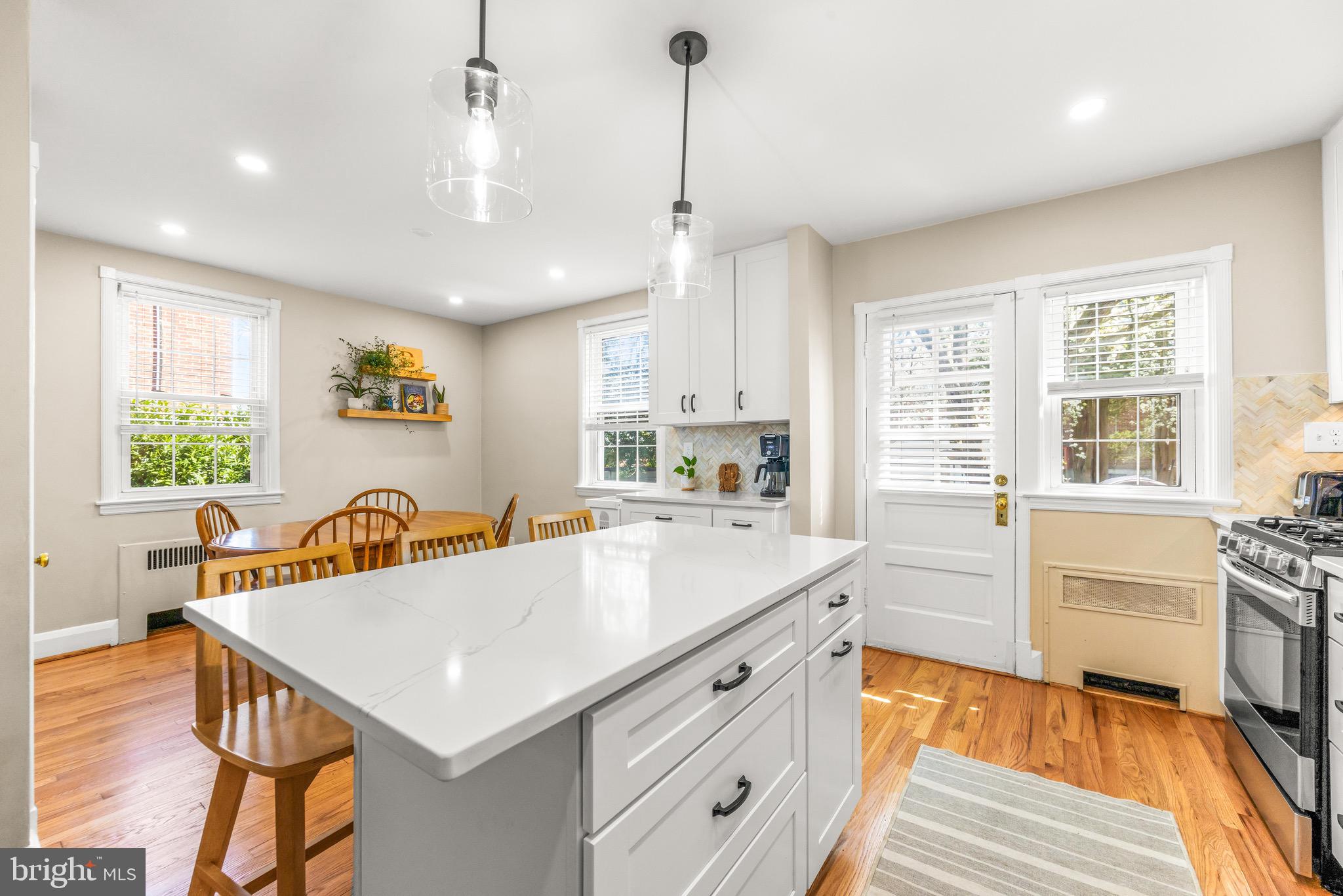 43 Murdock Road Baltimore, MD 21212 - Photo 13 of 42 a kitchen with a table chairs stove and wooden floor