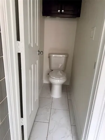 a white toilet sitting next to a sink