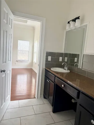 a bathroom with a sink a vanity and a mirror