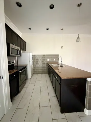 a kitchen with stainless steel appliances granite countertop a sink and a stove