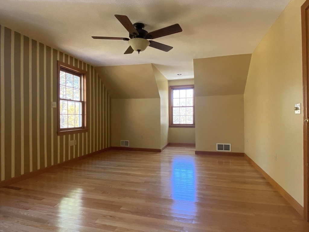 170 Bridge Street Warren, MA 01083 - Photo 21 of 34 an empty room with wooden floor fan and windows