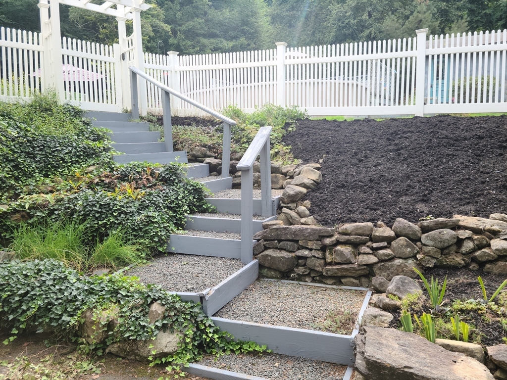 170 Bridge Street Warren, MA 01083 - Photo 7 of 34 a view of a house with a small yard and wooden fence