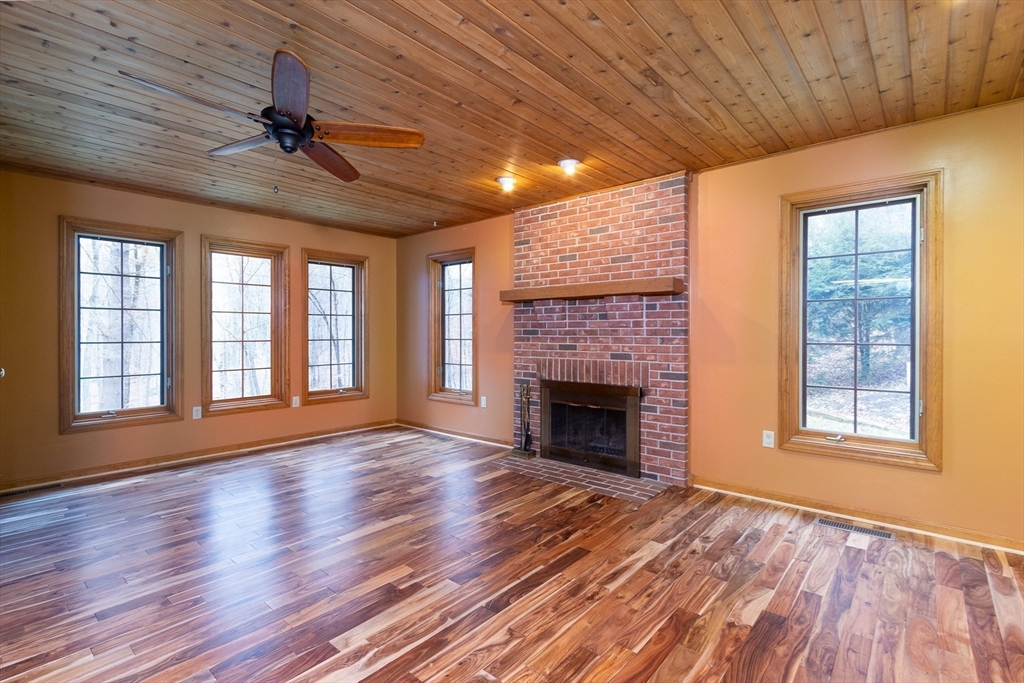 170 Bridge Street Warren, MA 01083 - Photo 9 of 34 a view of an empty room with wooden floor fireplace and a window