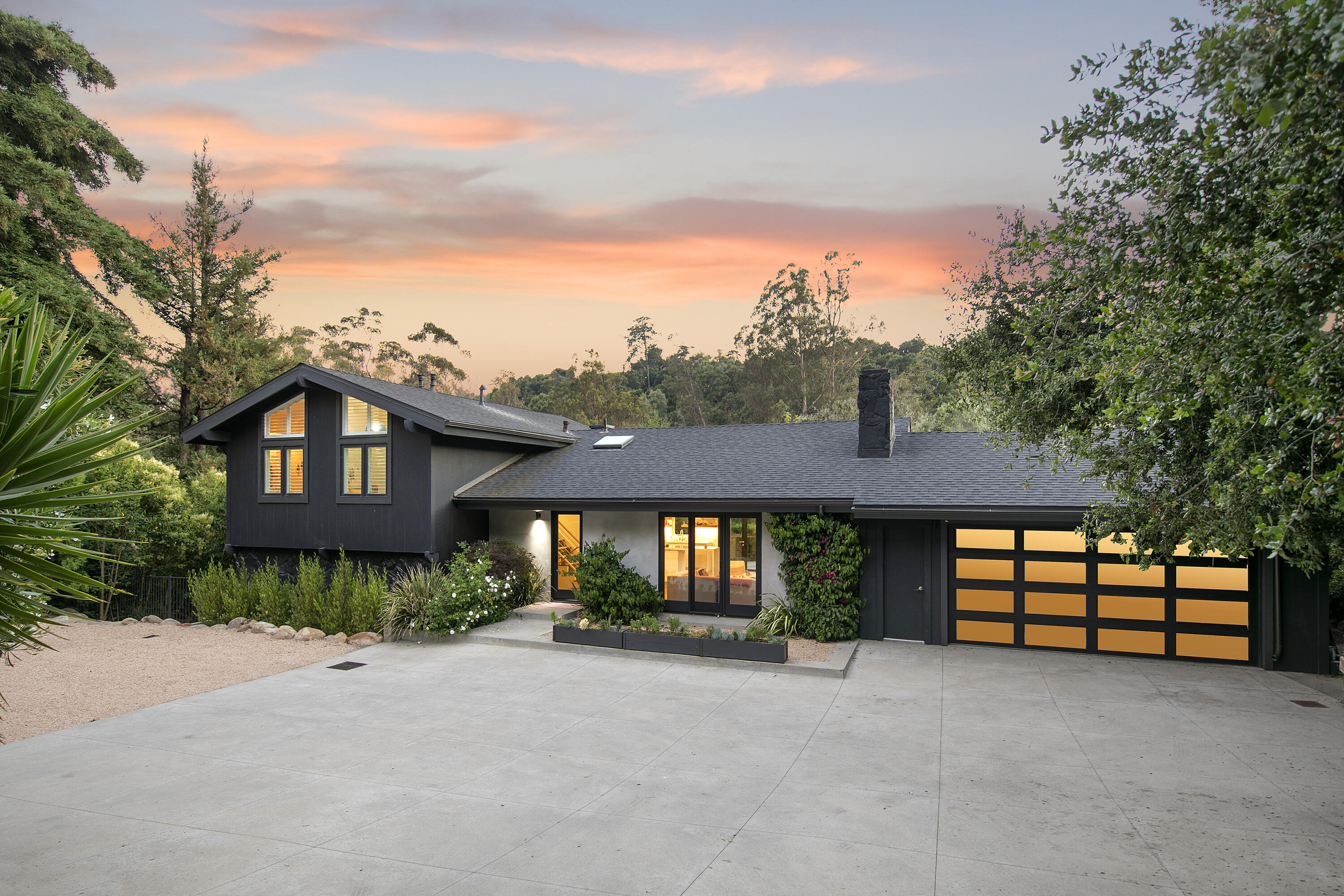 925 El Rancho Road Montecito, CA 93108 - Photo 1 of 28 a front view of a house with large trees