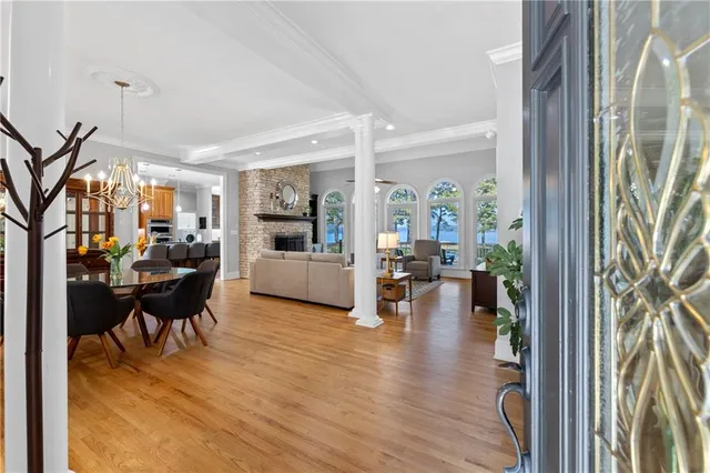 a living room with furniture a fireplace and a chandelier