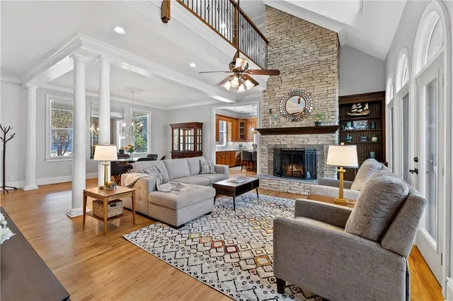 a bedroom with a bed a chandelier and a dresser