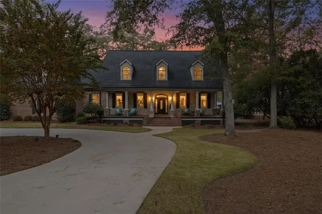 a view of a house with pool and chairs
