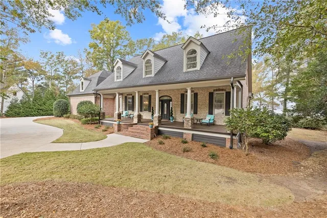 a front view of a house with a yard and trees