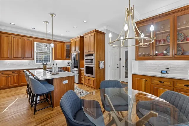 an empty room with wooden floor ceiling fan and window