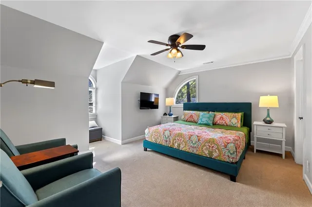 a front view of a house with a yard and large trees