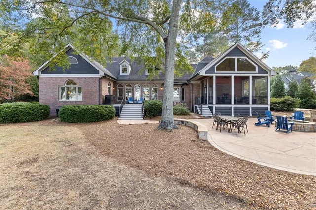 a dining room with furniture a chandelier and wooden floor