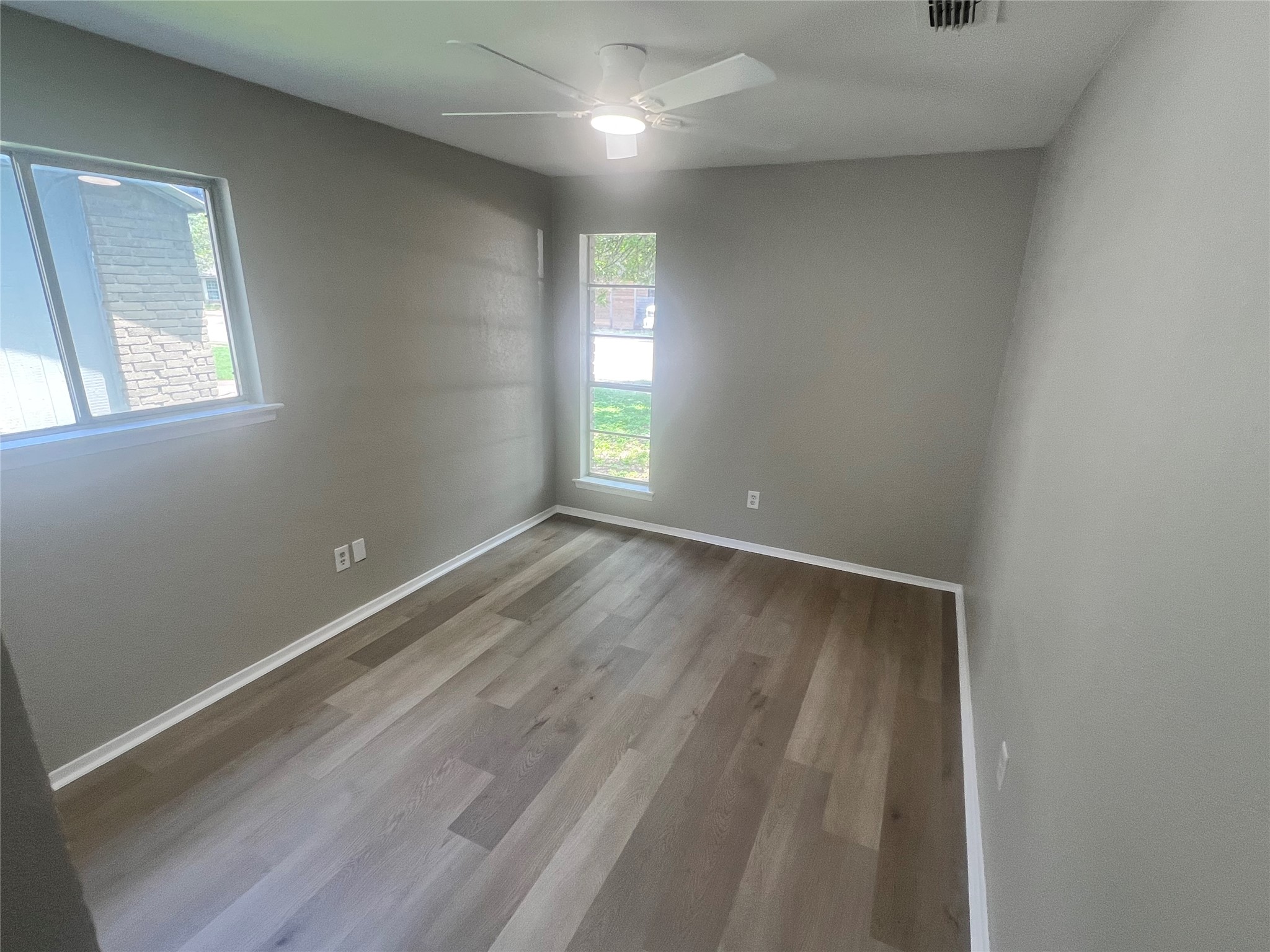 4620 Button Bend Road Austin, TX 78744 - Photo 17 of 22 Hardwood floors and a ceiling fan create a comfortable ambiance.