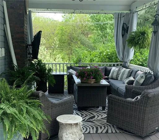 a living room with patio fireplace furniture and a potted plant