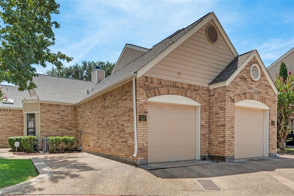 213 Cimarron Trail, Unit 4 Irving, TX 75063 - Photo 1 of 1 a view of a house with a small yard and potted plants