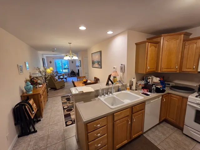 a kitchen with a sink a stove and cabinets