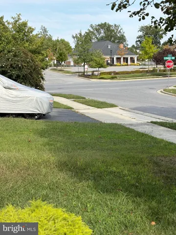 a backyard of a house with table and chairs and potted plants