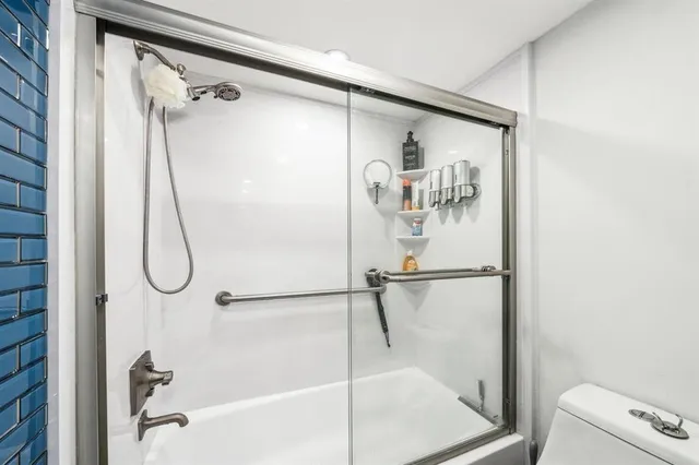 a bathroom with a glass shower door
