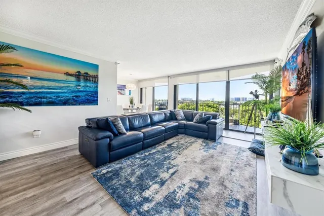 a living room with furniture plant and a window