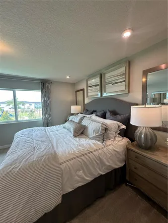 a living room filled with furniture and a floor to ceiling window