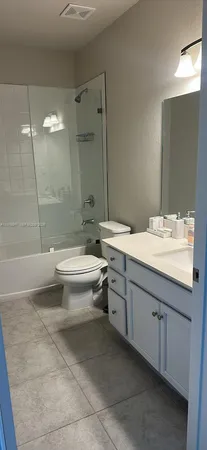 a bathroom with a double vanity sink toilet and shower