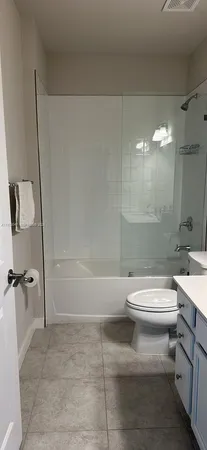 a bathroom with a toilet a sink and shower