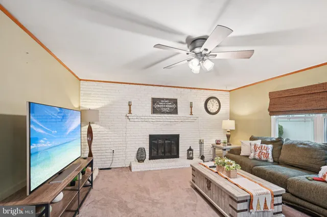 a living room with furniture flat screen tv and a fireplace