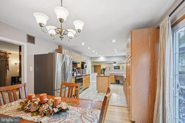 a view of kitchen with stainless steel appliances granite countertop furniture and a refrigerator