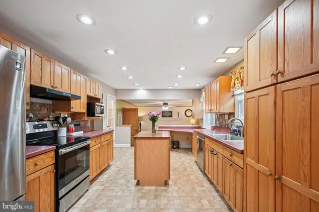 a large kitchen with stainless steel appliances lots of counter top space